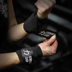 Medium Wrist Wraps, Black, 30CM/60CM - IPF Approved -Strength Shop WRIST WRAPS HEAVY BLKWHT Action 2 f0446748 1897 4ec9 b46d 020e70aff7b7